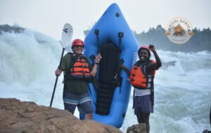 American lawyer tourist smiling after white water rafting adventure on the Nile River in Jinja, Uganda