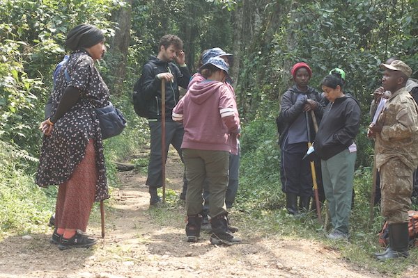 Tourist showing what to wear for gorilla trekking in Bwindi Impenetrable National Park.