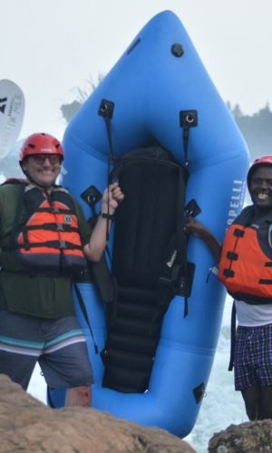 American lawyer tourist smiling after white water rafting adventure on the Nile River in Jinja, Uganda